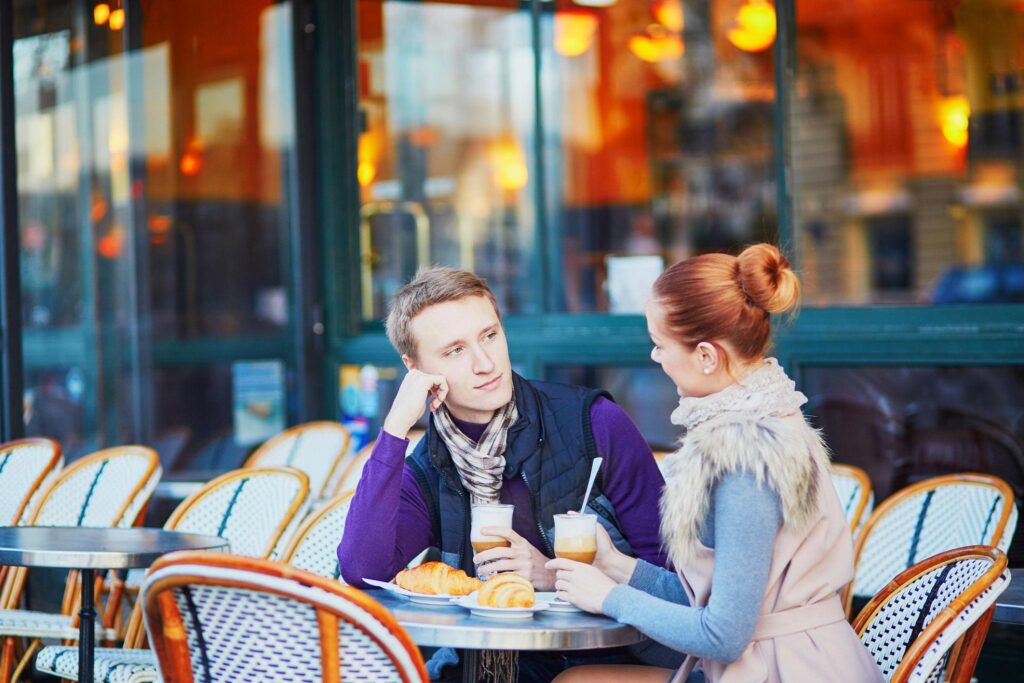 Romantic couple in Paris near Eiffel Tower during sunset for Valentine getaway trip in Europe